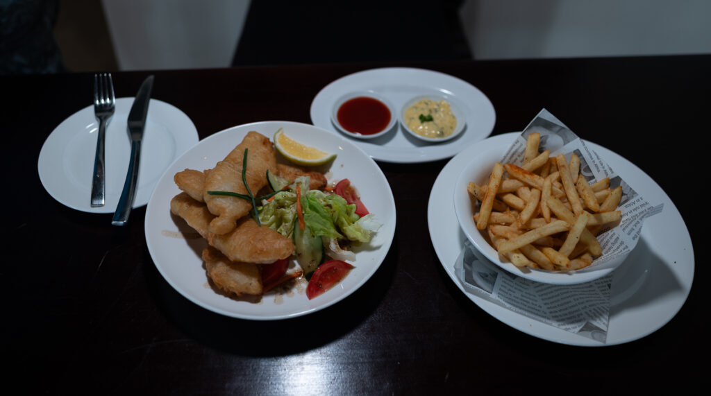 Crumbed fish with salad, fries and dipping sauces