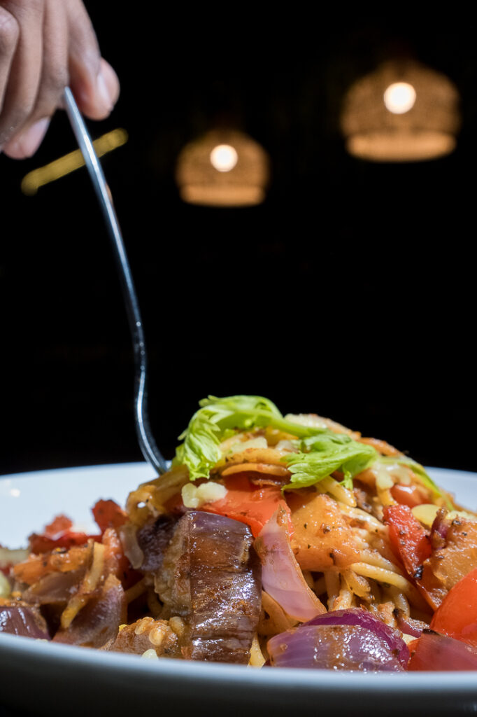 A forkful of pasta with vegetables